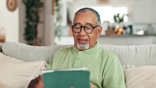 Senior Man Using Tablet at Home