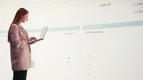 Comparing Profit Data Laptop and Businesswoman Using Charts