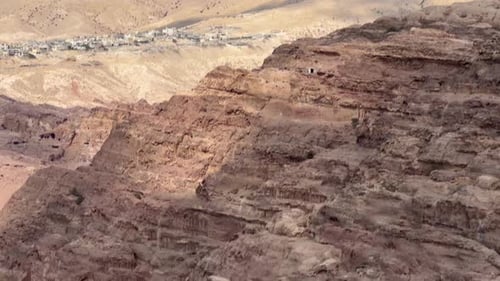 Tilt down to reveal tombs carved into the sandstone at Petra, Jordan