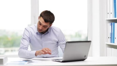 Man in Office Talking on Mobile Phone