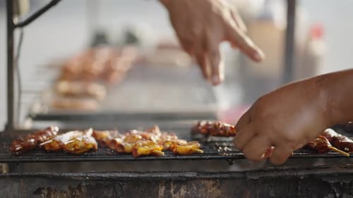 Thai Street Food Woman Flipping The Barbecue Skewers On Griller Over Charcoal