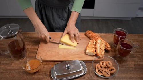 Woman slicing cheese on a cutting board