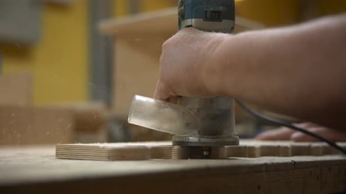 Close-up of Woodworking With Power Router Tool