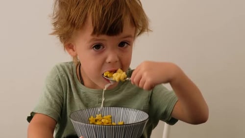 Niño comiendo cereales para el desayuno