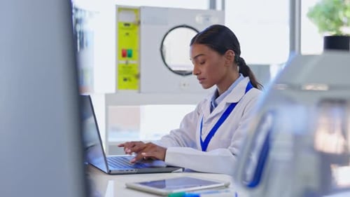 Woman Working on Laptop in Science Lab