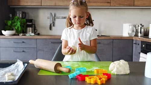 Child Baking Cookies in a Kitchen