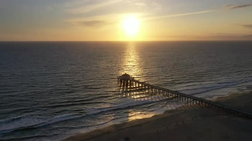 Sunset Reflecting In The Ocean Towards The Manhattan Beach Pier In California, USA. - aerial approac