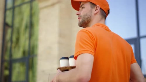 Back View Uniform Courier Going with Box and Coffee Cup Holder Along