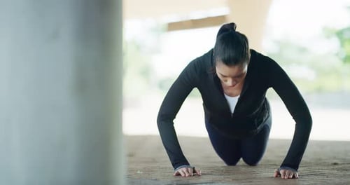 Athletic Woman Doing Pushups Outdoors