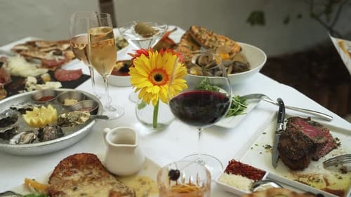Entrees and appetizers with wine and cocktails slow motion 4k 30p