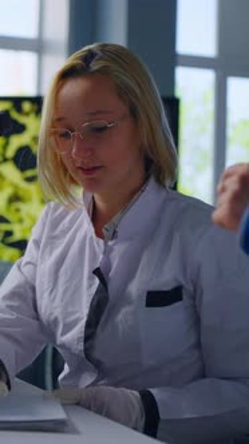 Scientist Woman in Lab Coat Writing Notes