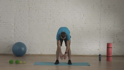 Man Fitness Coach in Sportswear Doing Back Stretch Warm Up for Online Class at the Home Studio HDR