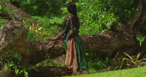 A young girl, dressed in traditional Indian wear, spends a delightful day at a tropical park in the