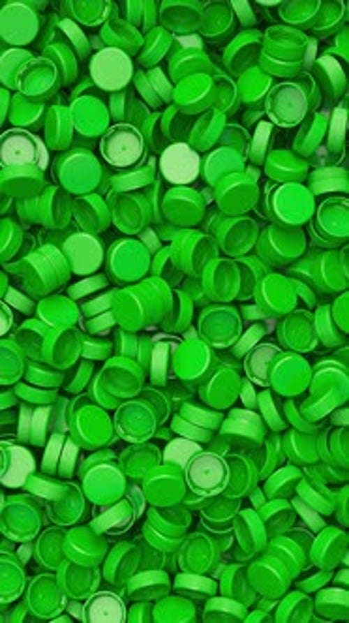 Pan Across a Pile of Green Plastic Bottle Caps for Recycling and Plastic Industry Production 3D