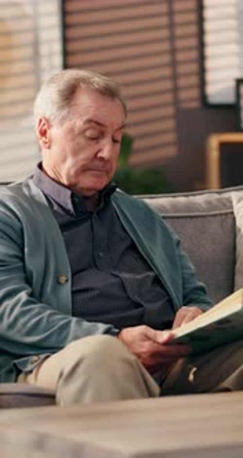 Senior Man Relaxing and Reading a Book at Home