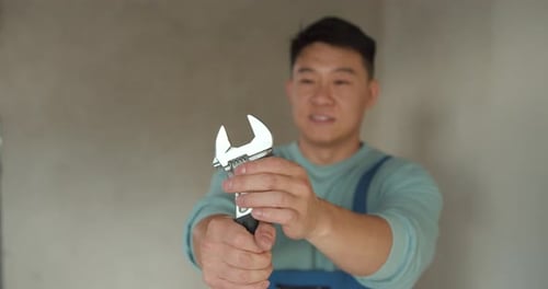 Handyman Worker Showing Up His Tools at Workplace