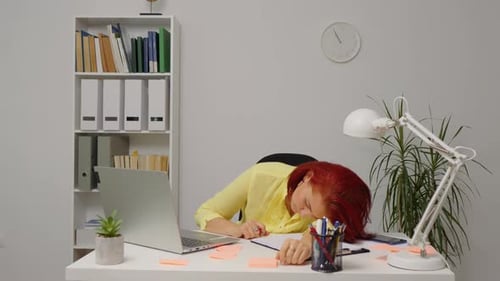 Tired Woman Sleeping at Her Desk