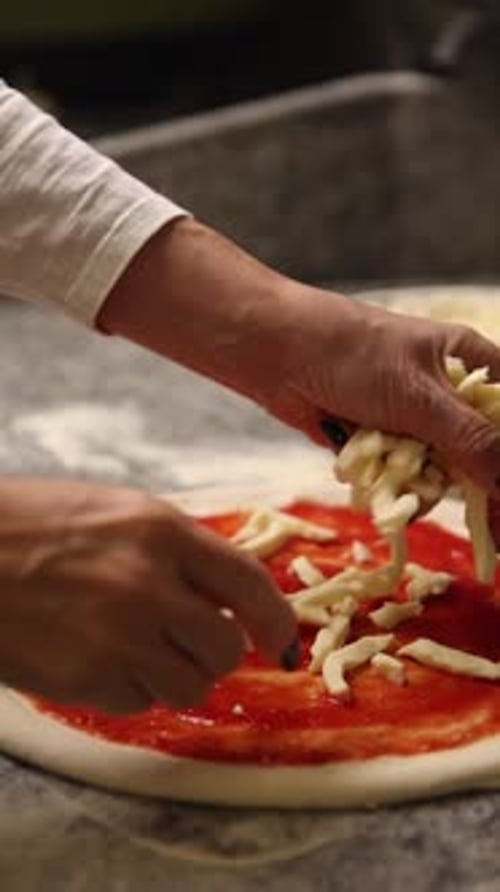 The chef makes delicious pizza in a professional kitchen.
