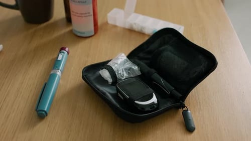 Insulin Pen and Medical Testing Kit on Table