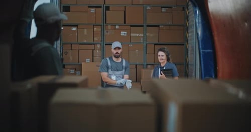 Multiethnic Workers Unloading Cardboard Boxes with Online Orders From Delivery Truck
