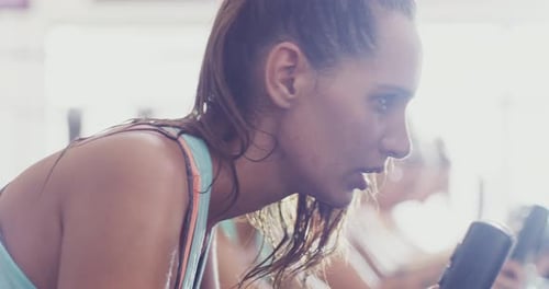 4k footage of a woman working out on an elliptical machine at the gym