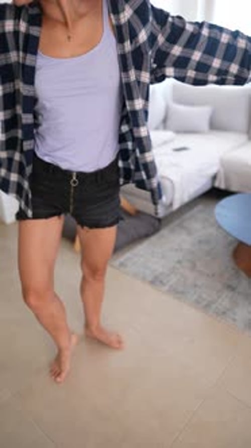 Young Woman Dancing Barefoot in Home Interior