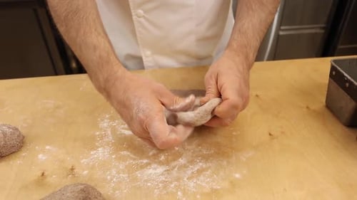 a chef makes bread in a bakery