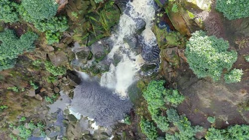 Aerial drone footage of a tall rocky waterfall in the Yorkshire Dales, Pennies. Moorland scene of a