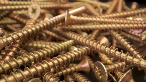CloseUp View of Gold Screws in a Pile