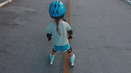 Girl learns roller skate. Girl learns roller skating in the urban safe area