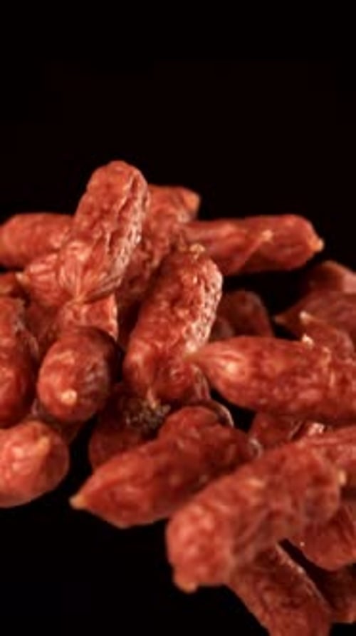 Mini Salami Fly and Fall on a Black Background Filmed on a Highspeed Camera at 1000 Fps