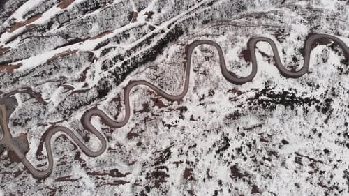 Aerial fly Mount Zao Stratovolcano, snowy winding Road and Rusty Terrain, Japan