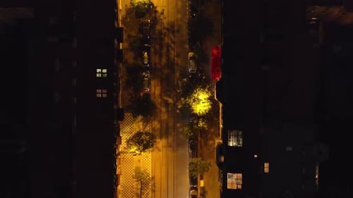 Aerial View of a Cars Crossing an Intersection in Prague at Night Cars are Parked on Both Sides of