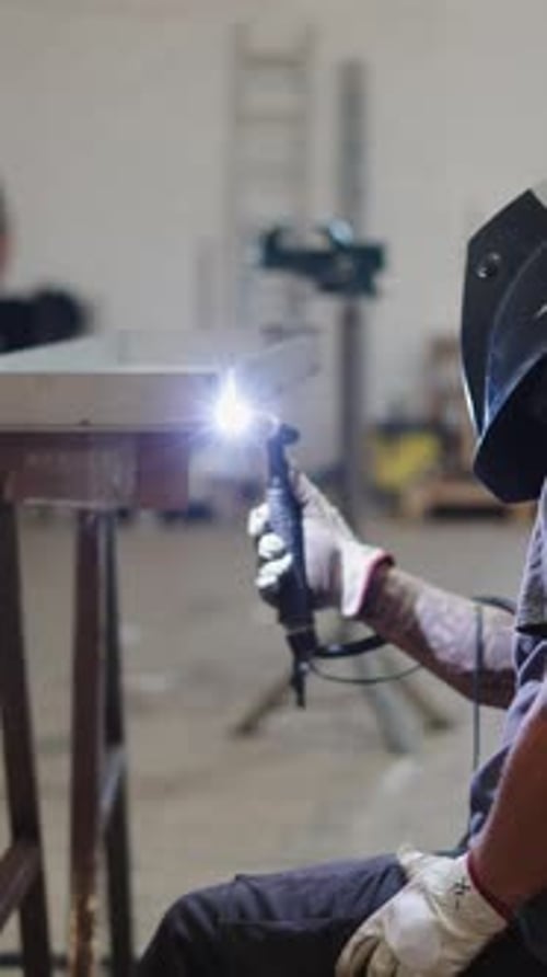 Professional Welder Joining Metal Pieces with Tig Welding Torch