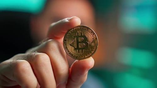 Golden Bitcoin Currency Held Close Up