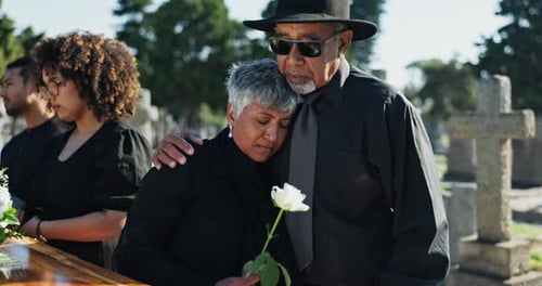 Graveyard, mature man and woman hug at funeral, memorial service or burial in empathy