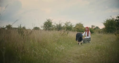 German Shepherd Approaching Woman on Autumn Meadow