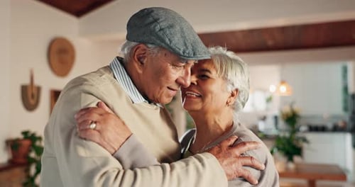 Loving Senior Couple Embracing at Home with Joy
