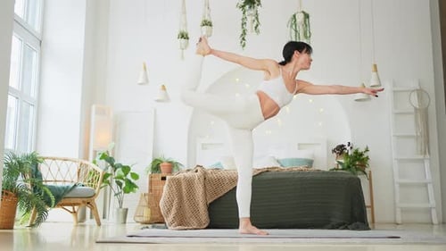 Fit Woman Performs Yoga Pose in Bright Room