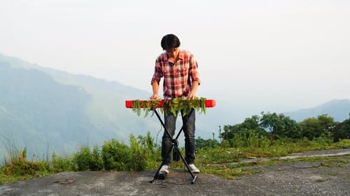 Young Adult Plays Keyboard Outdoors in Nature