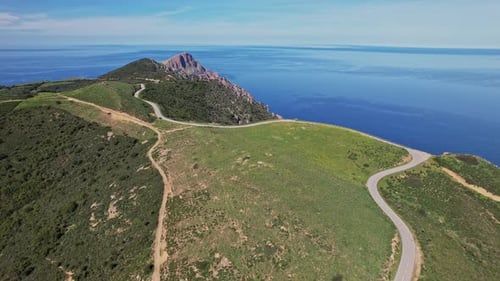 Aerial View of Winding Road by Ocean