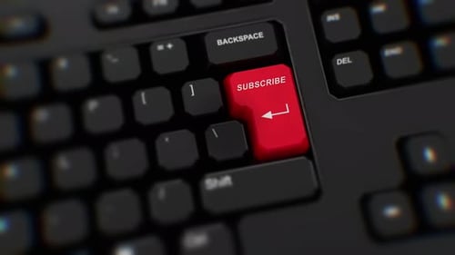 Subscribe button on keyboard close up. A finger presses Enter. Click SUBSCRIBE. Realistic keyboard