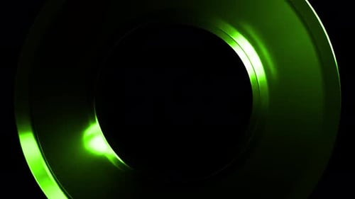 Green metallic torus rotating on black background
