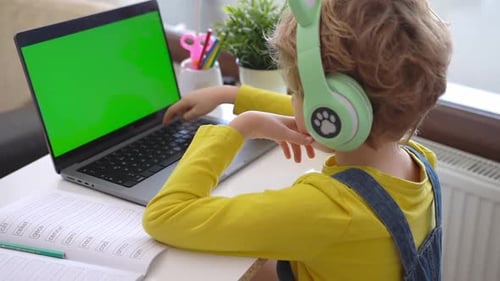 Child Studying on Laptop with Green Screen