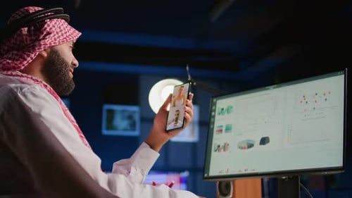 Man Video Conferencing at Desk in Office