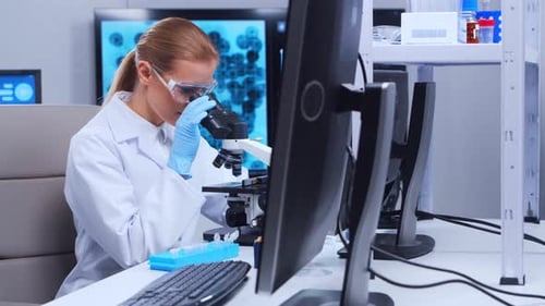 Scientist Using Microscope in Modern Laboratory