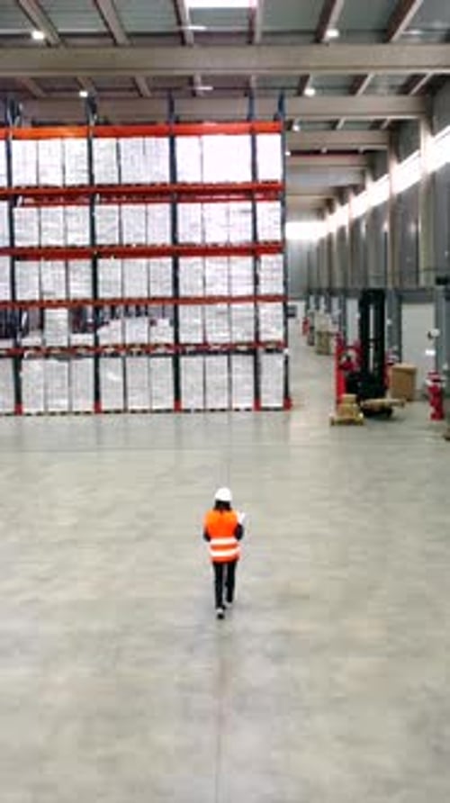 Warehouse worker walking through storage area