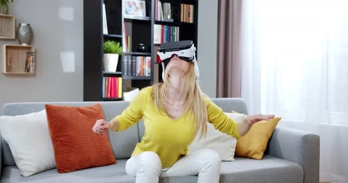 Woman Experiencing Virtual Reality on Couch