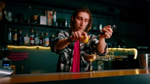 Bartender Grates Lemon Over Gold Cocktail Glass