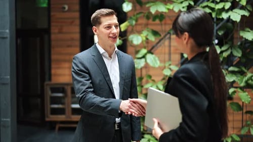 Business Meeting Handshake Businessman and Businesswoman in Modern Office
